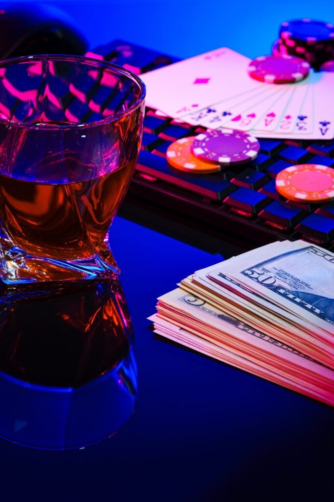 Game chips and cash on a dimly lit keyboard during an exciting gaming night at home
